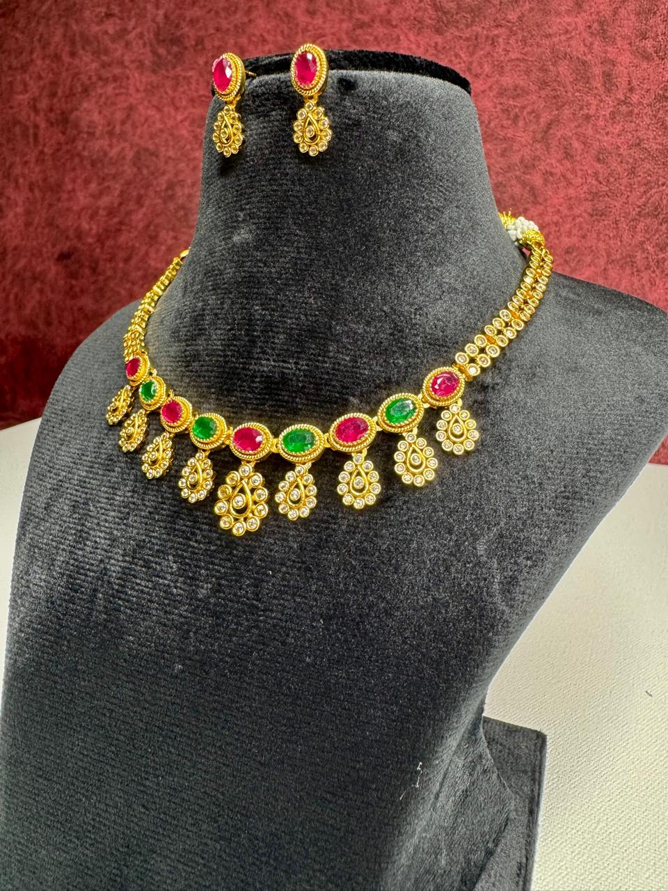 Elegant Gold-Plated Kundan Necklace Set with Red & Green Stones